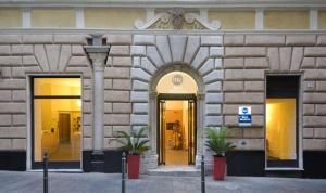 a building with two doors and two potted plants at Best Western Porto Antico in Genova