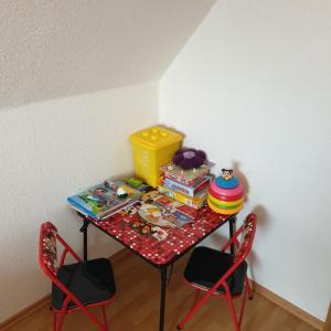 a small table with chairs and a table with toys on it at Ferienwohnung/Norden/4Personen in Norden