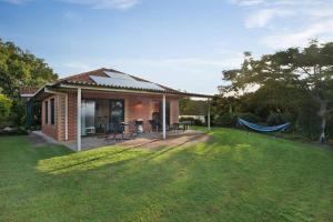 a small house with a hammock in a yard at Seascape The Haven in Scotts Head