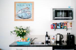 a kitchen with a microwave and a cupboard at La Costa Beachside Motel in Gold Coast
