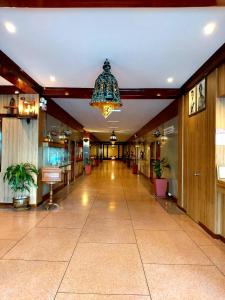 a hallway of a building with a chandelier at Suriwong Chumphon Hotel in Chumphon