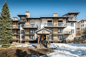 an apartment building with a clock on the front of it at Ptarmigan House in Steamboat Springs