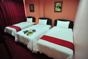 Postel nebo postele na pokoji v ubytování Puteri Ampang Hotel