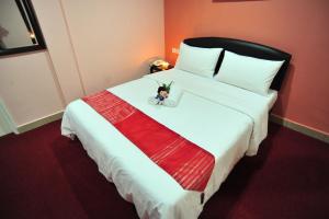Postel nebo postele na pokoji v ubytování Puteri Ampang Hotel