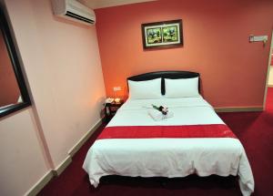 Postel nebo postele na pokoji v ubytování Puteri Ampang Hotel