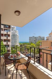 a balcony with a table and chairs and a view at Apartments Flora 1 in Burgas