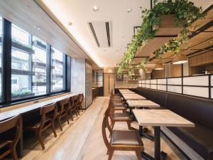 a row of tables and chairs in a restaurant at Super Hotel Hida Takayama in Takayama