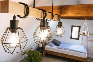 a group of lights hanging from a room with a bed at The Cozy Studio Apartment Lauf in Lauf an der Pegnitz