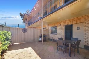 
a patio area with a patio table and chairs at Gossan Street Units in Broken Hill
