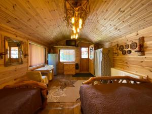 a room with two beds in a wooden cabin at Guest House Melon in Jūrmala