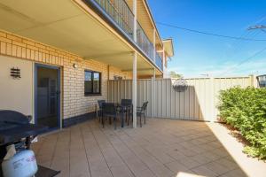 a patio area with a patio table and chairs at Gossan Street Units in Broken Hill