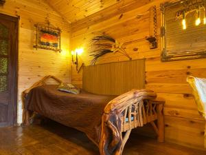 a bedroom with a bed in a log cabin at Guest House Melon in Jūrmala