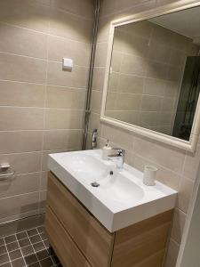 a bathroom with a white sink and a mirror at Apartment in Turku center in Turku +13 photos