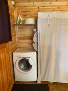 a washer and dryer in a tiny house at Guest House Melon in Jūrmala +19 photos