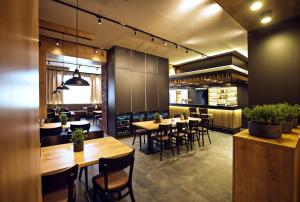 a restaurant with tables and chairs and a kitchen at Restaurace a Penzion Praha in Dolní Dunajovice