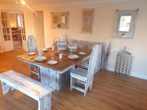 a wooden table and chairs in a living room at Sherwood Bungalow 3 Bedroom Entire Property in Boston