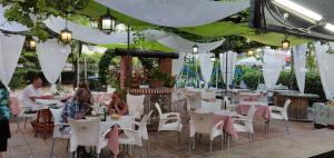 a group of people sitting at tables in a restaurant at El Tio Mateo in Marbella