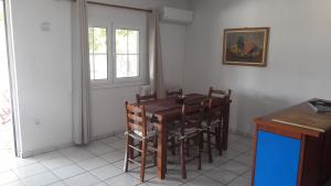 a dining room with a wooden table and chairs at Periyali in Keratea