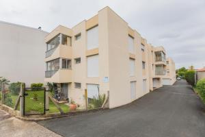an empty street in front of a building at Les Hauts de Perpigna in Royan