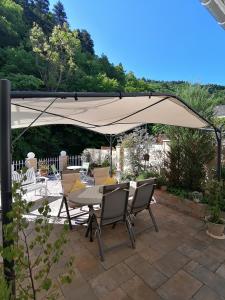 a patio with a table and chairs under an umbrella at Moni's Ferienwohnung in Bad Bertrich