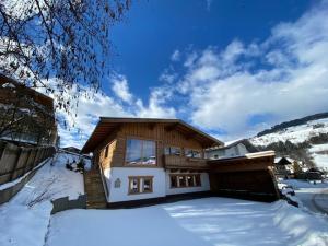 a large house with snow on the ground at Residence Cosy in Westendorf
