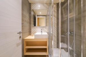 a bathroom with a sink and a shower at Iliorama Luxury Apartments in Skala Potamias