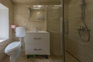a bathroom with a toilet and a shower and a sink at Krka Waterfalls in Skradin +28 photos