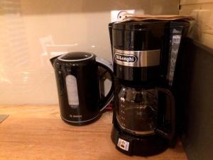 a black coffee maker sitting on top of a counter at Sarzynówka pod Świerkiem in Krasnobród