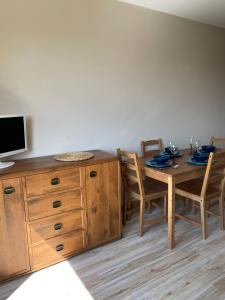 a dining room with a wooden table and chairs at Apartament w górach Gorce in Nowy Targ