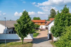 two trees in front of a house at Dorfzeit-Fleischhacker in Apetlon