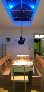 a wooden table in a room with a blue ceiling at Hostal, home sweet home in Salto