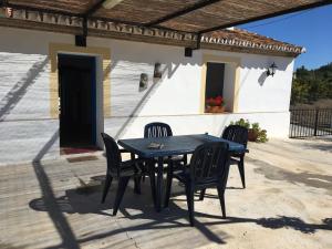 un tavolo nero e sedie su un patio di Casa Los Ruices a Benajarafe