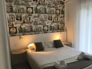 a bedroom with a bed and a wall with pictures at Prea Gianca in Bonifacio