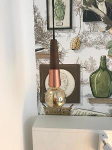 a lamp on top of a table next to a vase at Prea Gianca in Bonifacio