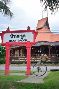 a bike parked under a sign in front of a restaurant at Baan Grood Arcadia Resort & Spa in Ban Krut