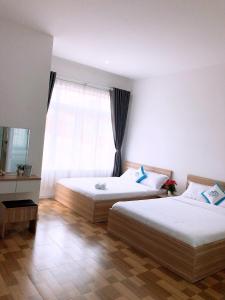 Postel nebo postele na pokoji v ubytování Homestay Tulip Garden Bảo Lộc