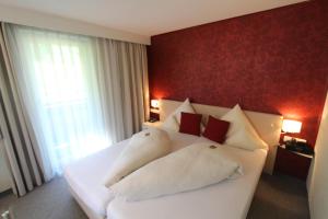 Postel nebo postele na pokoji v ubytování Hotel-Garni Fels