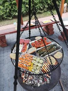 a grill with many different types of food on it at Morska Mila in Gąski