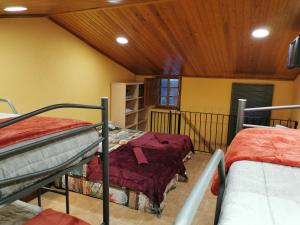 a room with two bunk beds and a wooden ceiling at Can Resiu in Serinyà +83 photos