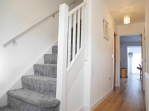 a staircase in a house with a stair case at Gill Gardens Penthouse, Ulverston in Ulverston