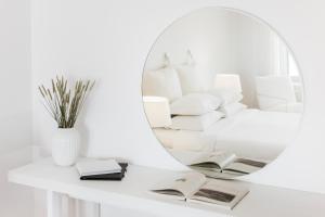 a white mirror sitting on top of a white table at Lilium Hotel Santorini in Fira
