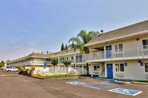 uma fila de edifícios de apartamentos com estacionamento em Motel 6-Sacramento, CA - South Sacramento and Elk Grove em Sacramento