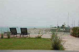 two chairs sitting on the beach near the water at Saint Joseph in Salerno