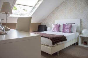 a bedroom with a white bed with purple pillows at O'Porto Seven - Guest House in Porto