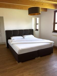 a bedroom with a large bed with a black headboard at LaVita in Lengerich