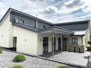 a white house with a black roof at LaVita in Lengerich