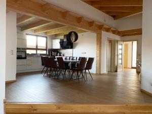 a kitchen and dining room with a table and chairs at LaVita in Lengerich