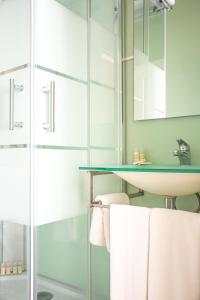 a bathroom with a sink and a glass shower at O'Porto Seven - Guest House in Porto