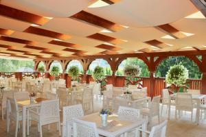 a banquet hall with white tables and white chairs at Hotel Alex in Sankt Kanzian