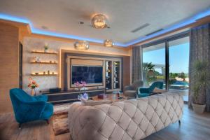 a living room with a large couch and chairs at Villa Salute in Budva
